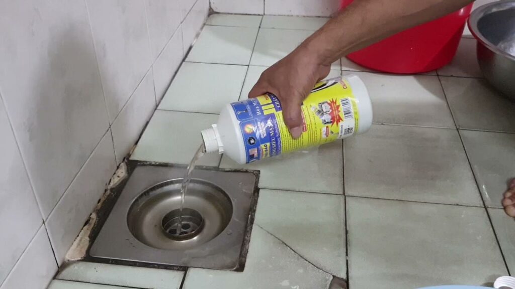 Kỹ thuật viên URENCO đổ dung dịch chuyên dụng hỗ trợ khơi thông cống tại thị trấn Chờ